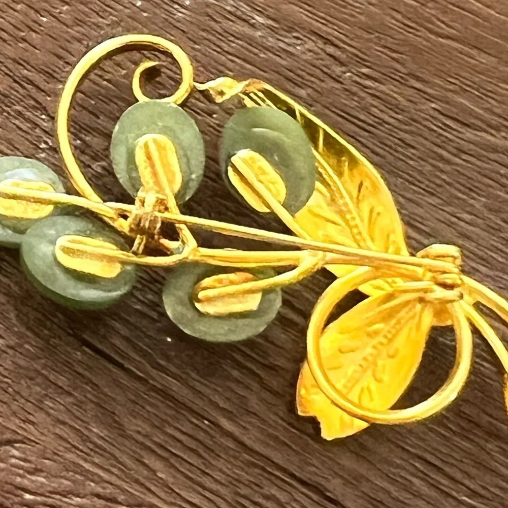 Vintage plated brooch with vines and engraved leaves.